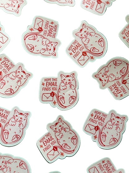 A collection of white die-cut stickers featuring a red line-art illustration of a cat with an envelope and the text 'HOPE THIS EMAIL FINDS YOU'