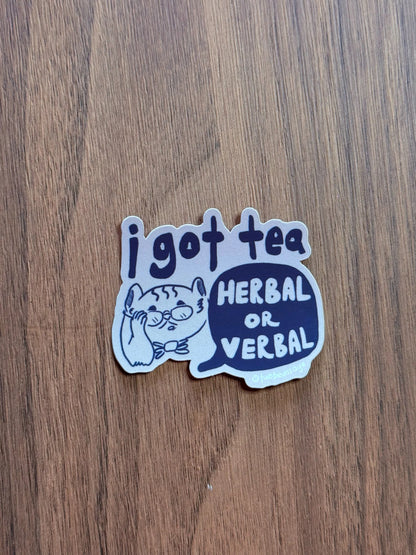 A die-cut sticker featuring a cartoon cat and the text 'i got tea' and 'HERBAL OR VERBAL'